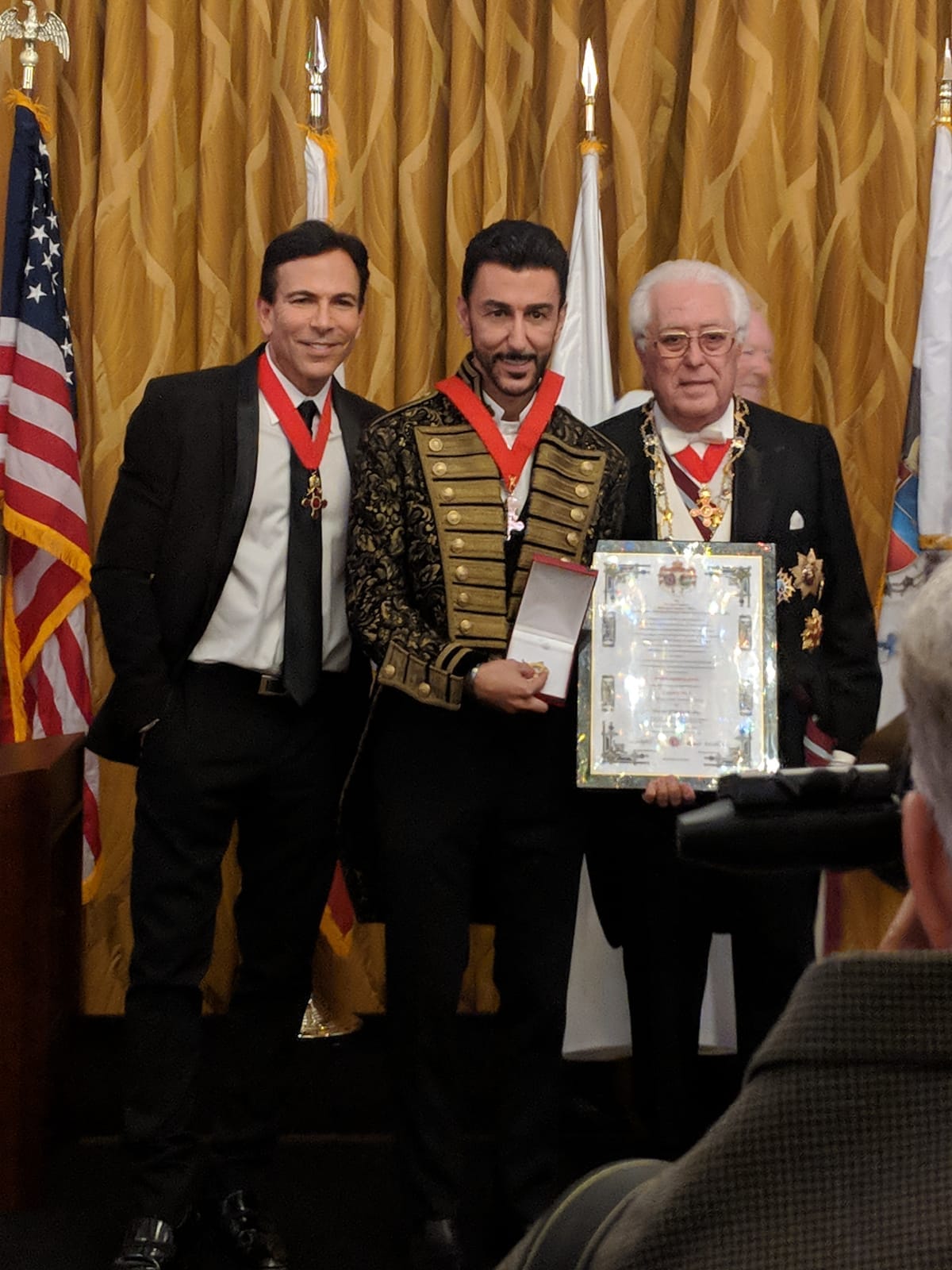 Bibop Gresta at Knighthood ceremony with certificate